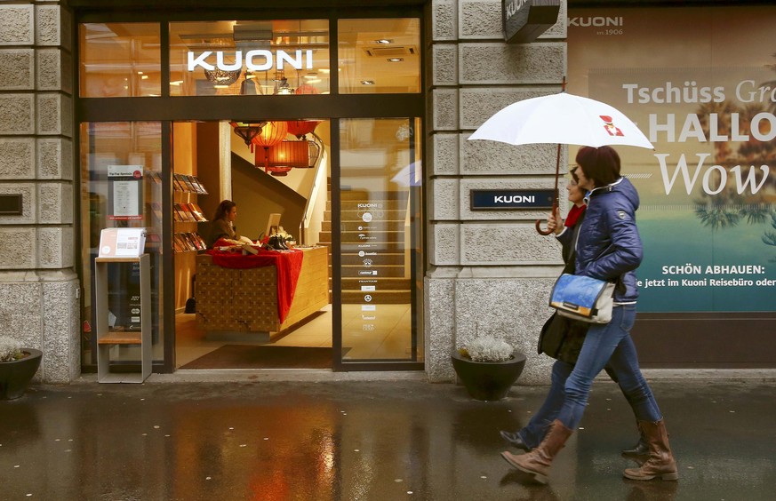 People walk past a travel bureau of Swiss travel group Kuoni Switzerland in Zurich January 14, 2015. Kuoni shares jumped 7 percent after saying it would exit from tour operating activities as it focus ...