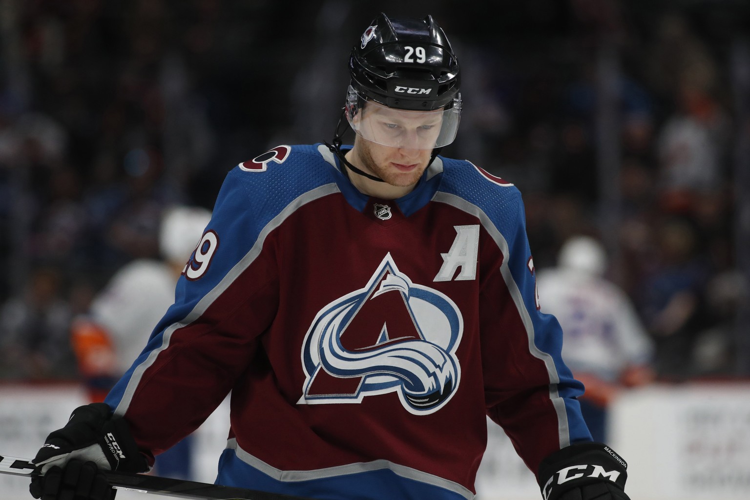 FILE - Colorado Avalanche center Nathan MacKinnon waits for a face off against the New York Islanders in the second period of an NHL hockey game in Denver, in this Wednesday, Feb. 19, 2020, file photo ...