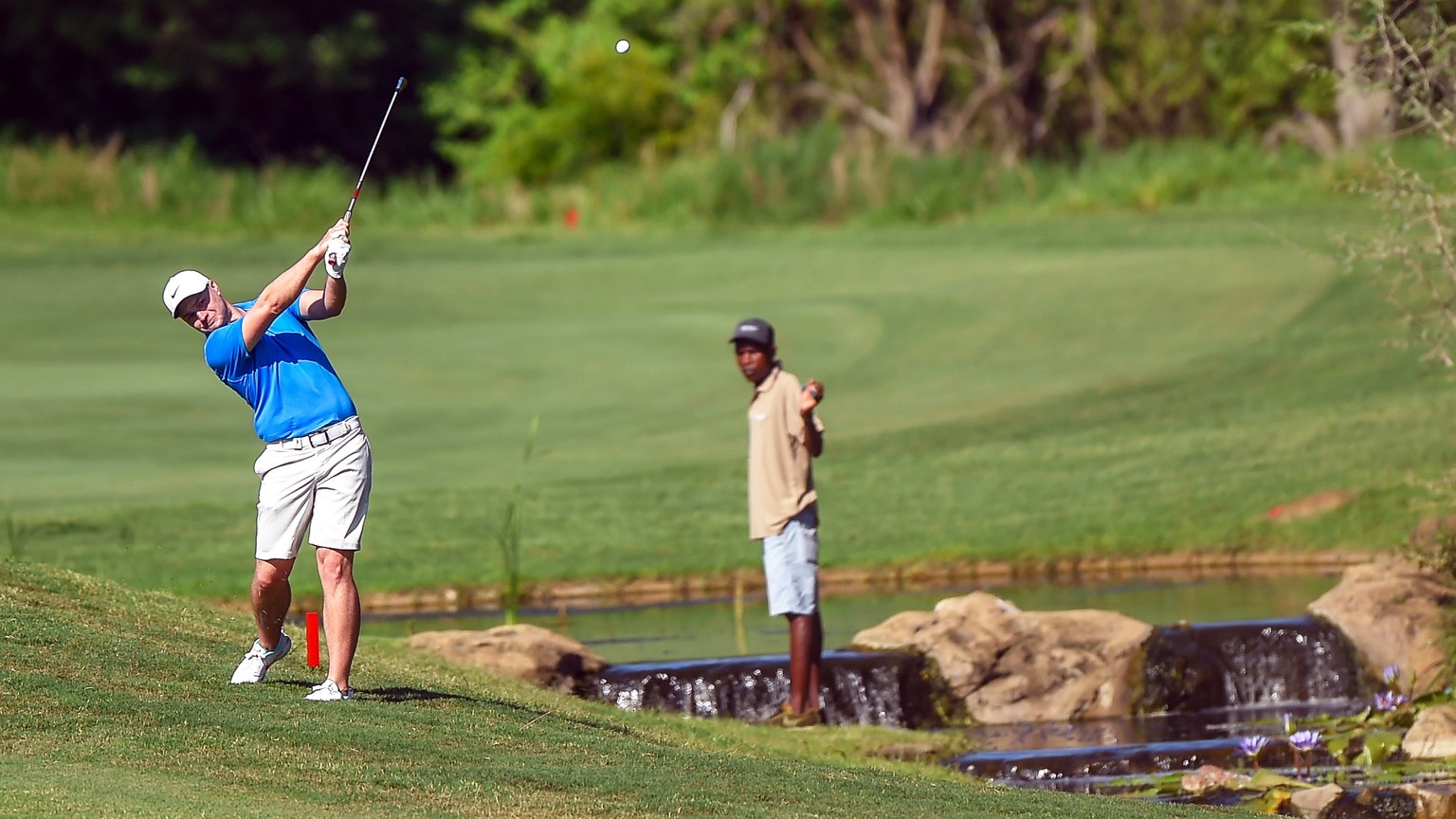 epa08032578 England&#039;s Oliver Fisher (L) plays a shot on the 13th on the second day of the Alfred Dunhill Championship at the Leopard Creek Golf Course in Nelspruit, South Africa, 29 November 2019 ...