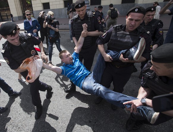 FILE - In this file photo taken on Saturday, May 30, 2015, Russian police officers detain gay rights activist Nikolai Alexeyev during an attempt to hold a gay demonstration in Moscow, Russia. The U.S. ...