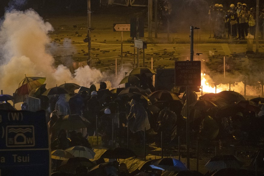 Protesters battle against riot police firing tear gas outside the Hong Kong Polytechnic University in Hong Kong Monday, Nov. 18, 2019. Fiery explosions were seen early Monday as Hong Kong police storm ...
