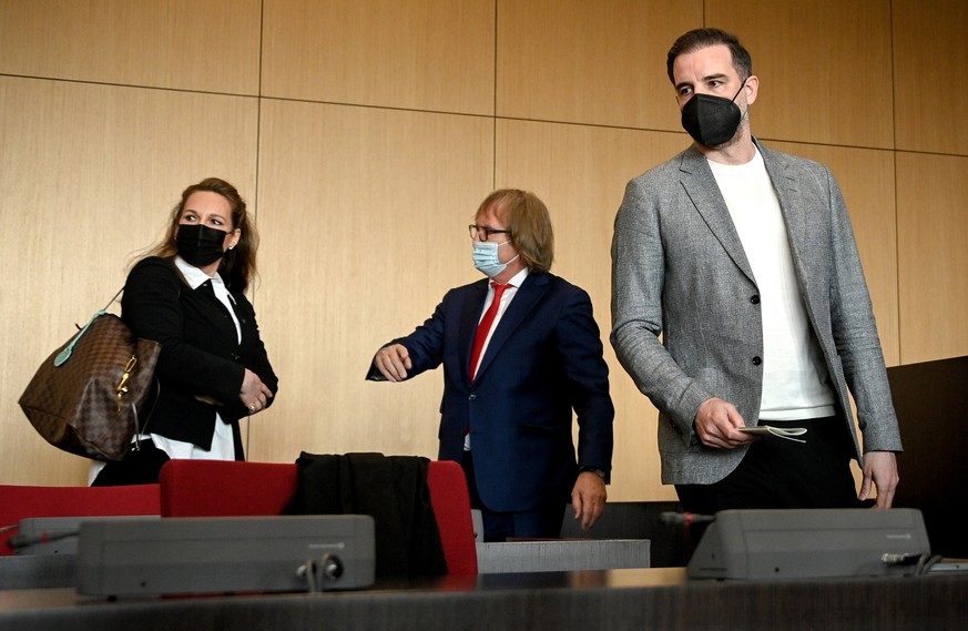epa09167079 Defendant Christoph Metzelder (R) and his attorneys arrive in the courtroom for his trial at the District Court in Duesseldorf, Germany, 29 April 2021. Charges have been brought against fo ...