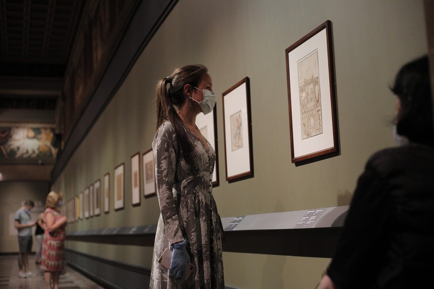 A visitors wearing a face mask to protect against coronavirus, looks at the exhibition &quot;From Durer to Matisse Selected drawings&quot; from the collection of the Pushkin State Museum of Fine Arts  ...