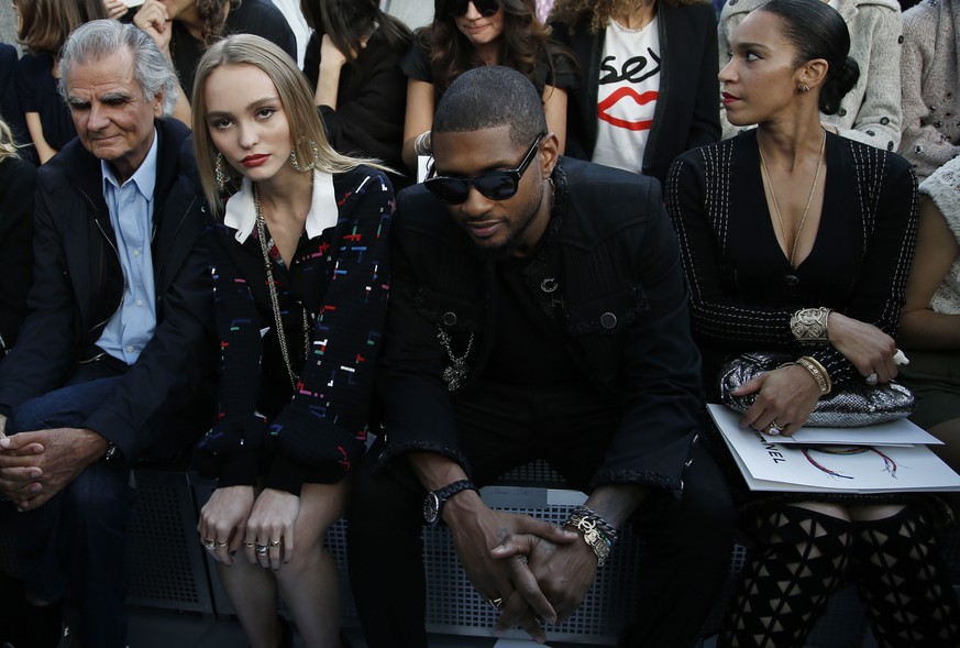 From left, Patrick Demarchelier, Lily Rose Depp, Usher and an unidentified person wait prior Chanel&#039;s Spring-Summer 2017 ready-to-wear fashion collection presented Tuesday, Oct.4, 2016 in Paris.  ...