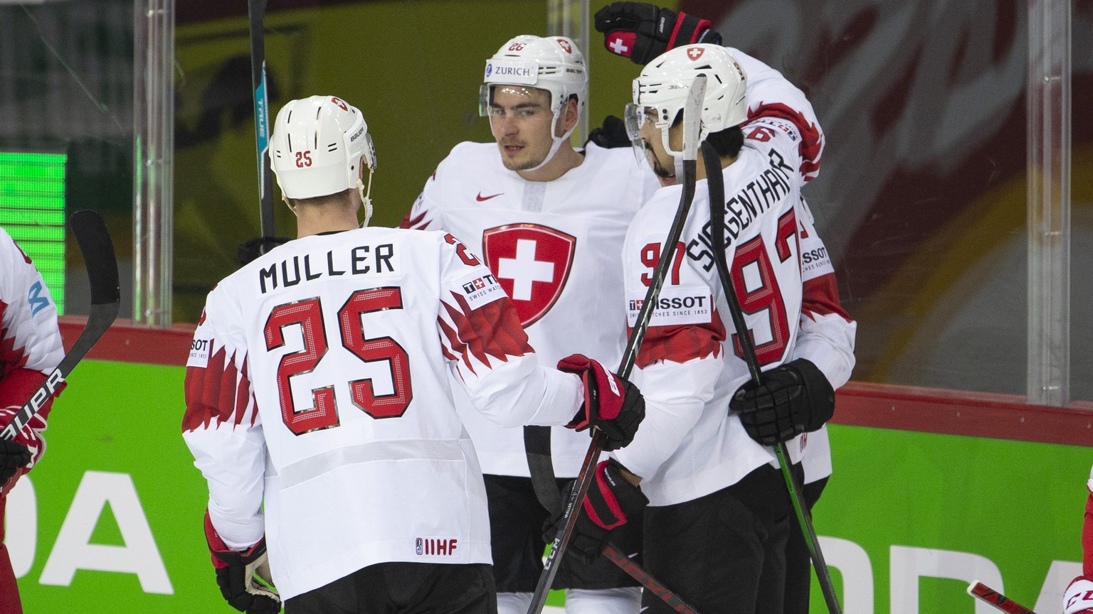 Switzerland&#039;s forward Timo Meier, center, celebrates his goal with teammates defender Mirco Mueller, left, and defender Jonas Siegenthaler, right, after scoring the 0:1, during the IIHF 2021 Worl ...