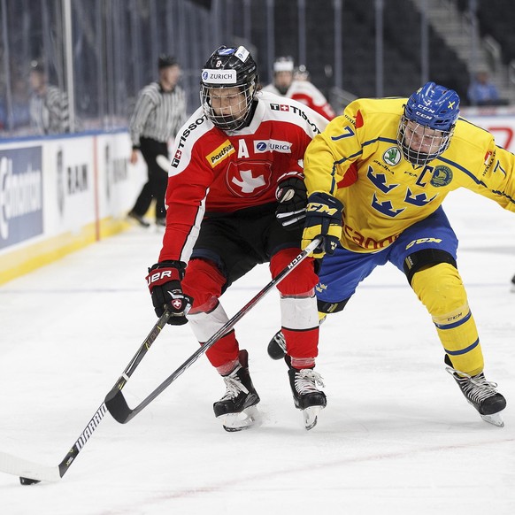 Sweden&#039;s Tobias Bjornfot (7) pursues Switzerland&#039;s Simon Knak (8) during the third period of a Hlinka Gretzky Cup game in Edmonton, Alberta, Tuesday, Aug. 7, 2018. (Codie McLachlan/The Canad ...