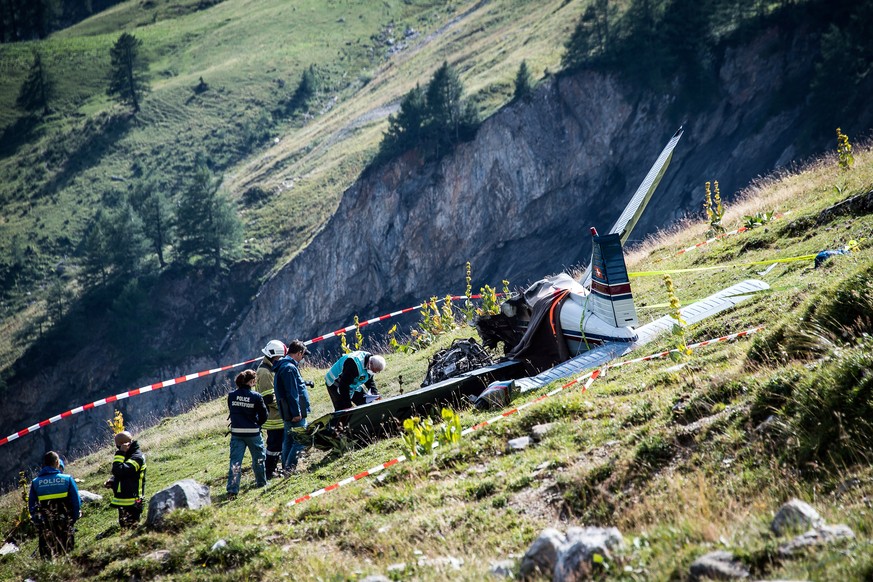 A rescue team works at the scene of the crash where a passenger plane crashed on Sunday August 20 2017 at the pass of Sanetsch in Valais, Switzerland. Three people died in the crash of the Piper 28 th ...