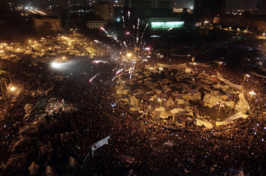epa05750042 (FILE) - A file picture dated 11 February 2011, shows Egyptian anti-government protesters celebrate minutes after the announcement on television of the resignation of President Hosni Mubar ...