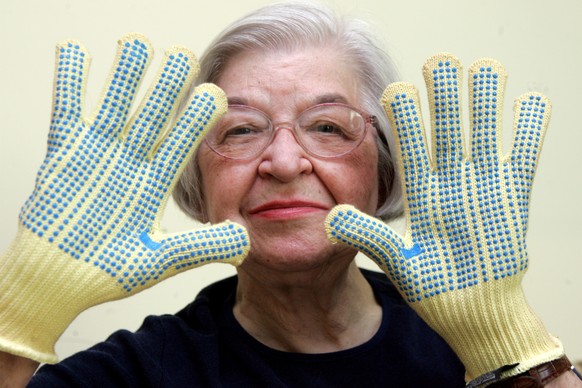 FILE - Stephanie Kwolek, 83, shown in this June 20, 2007 file photo taken in Brandywine Hundred, Del., she wears regular house gloves made with the Kevlar she invented. Her friend, Rita Vasta, told Th ...