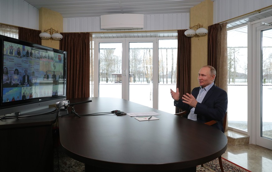 Russian President Vladimir Putin gestures as he takes part in a meeting with university students marking Russian Students&#039; Day via video conference in Zavidovo, 150 km (90 miles) north of Moscow, ...