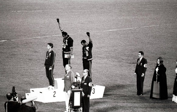 1968 Olympic Games, Mexico City America s gold and bronze medallists Tommie Smith centre and John Carlos right raise their arms as a Black Power gesture during the Olympic Awards Ceremony. Smith had s ...