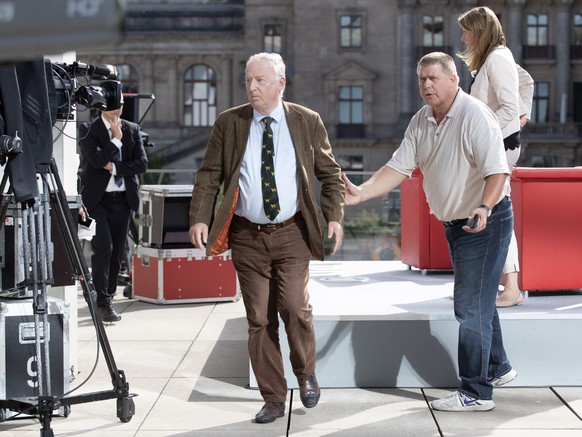 epa07844528 Federal co-chairman of the Alternative for Germany (AfD) right-wing populist party Alexander Gauland (L) leaves the traditional summer interview of the television show &#039;Report from Be ...