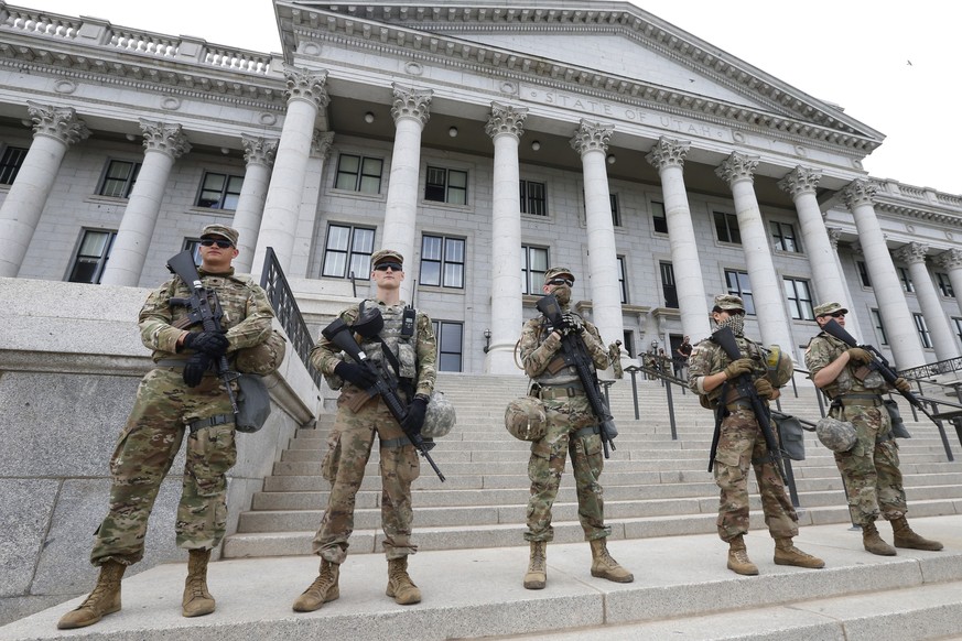 Utah National Guard troop stand guard on the steps of the Utah State Capitol Thursday, June 4, 2020, in Salt Lake City. More than a thousand people filled the street across from the Utah State Capitol ...
