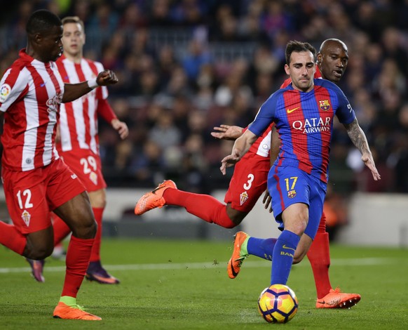 FC Barcelona&#039;s Paco Alcacer, right, duels for the ball during the Spanish La Liga soccer match between FC Barcelona and Sporting Gijon at the Camp Nou stadium in Barcelona, Spain, Wednesday, Marc ...