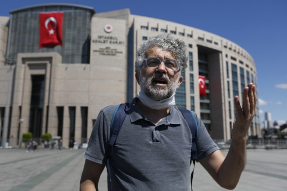 Erol Onderoglu, the Reporters Without Borders Turkey organisation representative talks outside a court in Istanbul, Thursday, July 16, 2020, where the trial of Deniz Yucel, a German-Turkish journalist ...