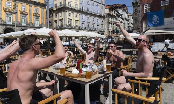 epa09232991 Manchester City and Chelsea supporters drink beer and cheer at Ribeira in Porto, Portugal, 28 May 2021. Porto hosts the UEFA Champions League final between Manchester City and Chelsea on 2 ...