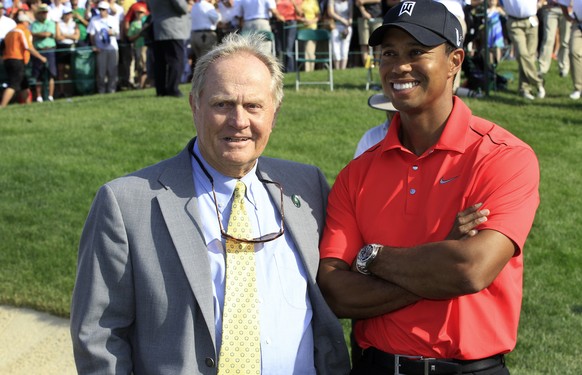 File-This June 3, 2012, file photo shows Jack Nicklaus, left, and Tiger Woods talking after Woods won the Memorial golf tournament at the Muirfield Village Golf Club in Dublin, Ohio. Nicklaus says he  ...