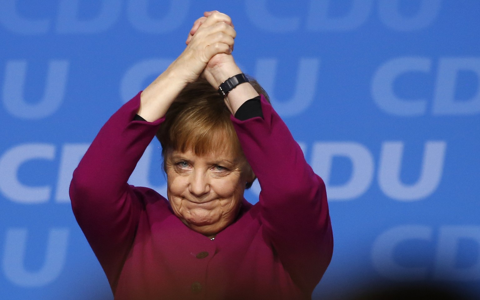 FILE - In this Feb. 26, 2018 file photo, German Chancellor and party chairwoman Angela Merkel acknowledges the applause of the delegates after her speech during the party convention of the Christian D ...
