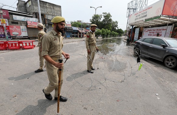 epa07757496 Jammu and Kashmir police men stand guard during a curfew in Jammu, the winter capital of Kashmir, India, 05 August 2019. Indian Home Minister Amit Shah moved a resolution in the parliament ...