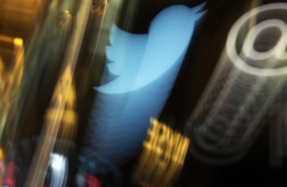 FILE - In this Wednesday Nov. 6, 2013, file photo, the Twitter logo appears on an updated phone post on the floor of the New York Stock Exchange. Twitter says the hackers responsible for a recent high ...