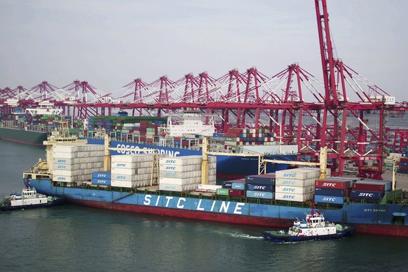 Two barges push a container ship to the dockyard in Qingdao in eastern China&#039;s Shandong province Wednesday, May 8, 2019. China&#039;s exports fell unexpectedly in April, adding to pressure on Bei ...