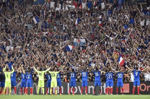 France players celebrate with the supporters at the end of the Euro 2016 semifinal soccer match between Germany and France, at the Velodrome stadium in Marseille, France, Thursday, July 7, 2016. (AP P ...