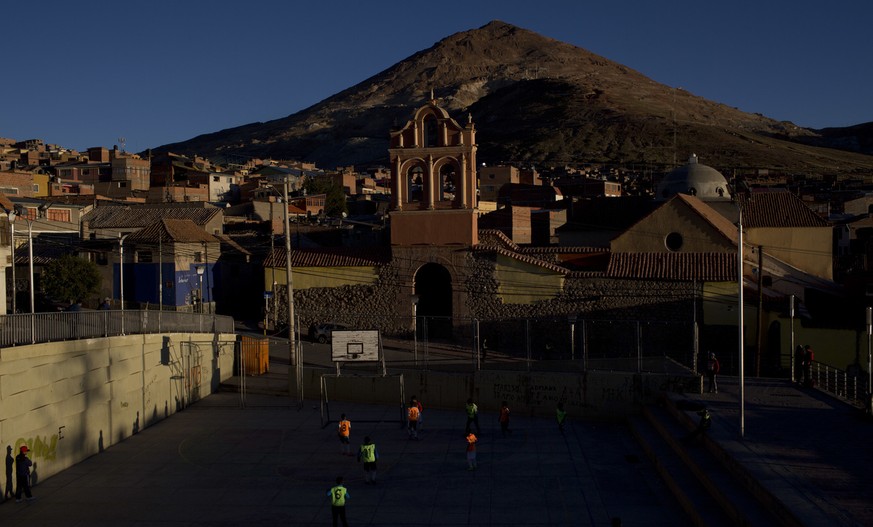 Children play soccer on the court next to &quot;Cerro Rico,&quot; in Potosi, Bolivia, Thursday, May 10, 2018. Cerro Rico is a mountain in the Andes famous for providing vast quantities of silver for S ...