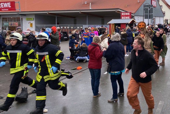 epa08244551 Peaopl react after a car crashed into a group of revelers during the Rose Monday carnival parade in Volkmarsen near Kassel, Germany 24 February 2020. According to reports, a man drove a ca ...