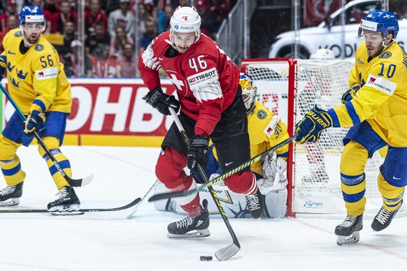 Switzerland&#039;s Noah Rod, left, against Sweden`s Alexander Wennberg during the game between Sweden and Switzerland, at the IIHF 2019 World Ice Hockey Championships, at the Ondrej Nepela Arena in Br ...