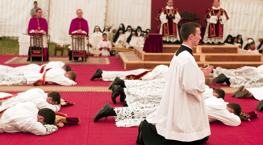 Priests pray on the floor during an ordination ceremony in Econe, southwest Switzerland June 29, 2009. Earlier this year, Pope Benedict XVI lifted the excommunication of the four Bishops of the SSPX ( ...