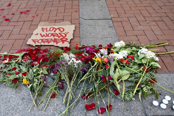 epa09062372 Protesters placed flowers outside the Hennepin County Government Center as jury selection was to begin in the trial of former officer Derek Chauvin in the killing of George Floyd, Minnesot ...
