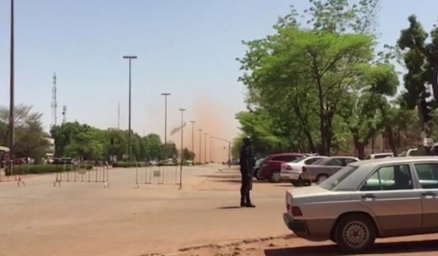 A helicopter flies away after landing in central Ouagadougou, Burkina Faso in this image taken from video Friday March 2, 2018. Gunfire and explosions rocked Burkina Faso’s capital early Friday in wha ...