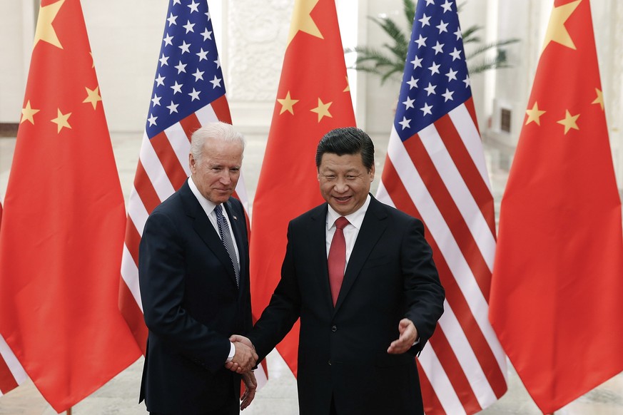 FILE - In this Dec. 4, 2013, file photo, Chinese President Xi Jinping, right, shakes hands with then U.S. Vice President Joe Biden as they pose for photos at the Great Hall of the People in Beijing. ( ...