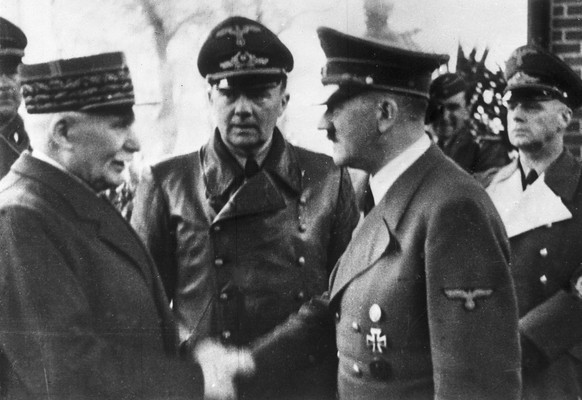 FILE - This Oct. 24, 1940 file photo shows German Chancellor Adolf Hitler, right, shaking hands with Head of State of Vichy France Marshall Philippe Petain, in occupied France. Behind centre is Paul S ...