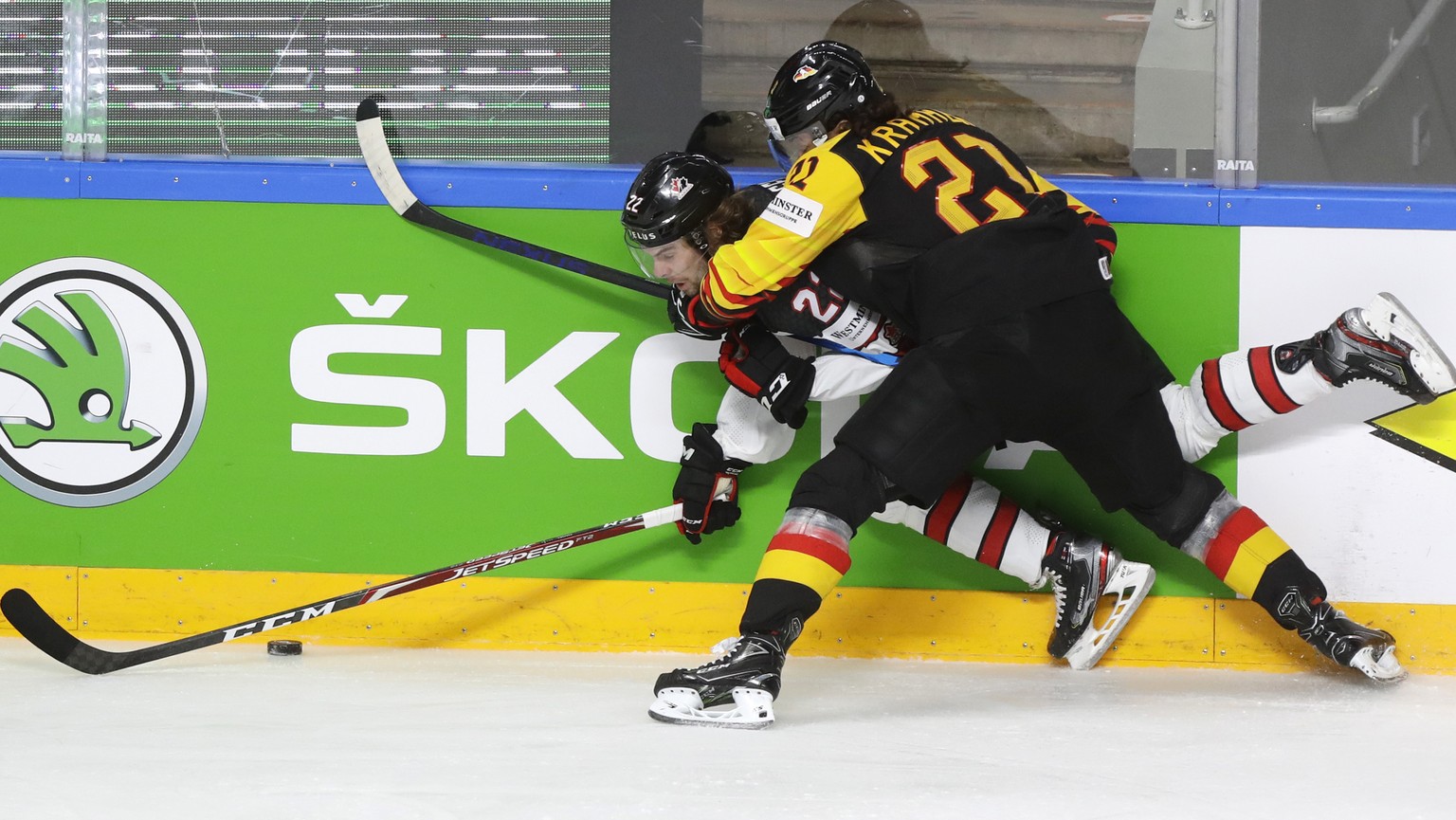 Canada&#039;s Brandon Hagel, left, challenges for the puck with Germany&#039;s Nikolas Krammer during the Ice Hockey World Championship group B match between Germany and Canada at the Arena in Riga, L ...
