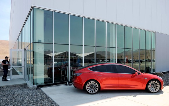 A prototype of the Tesla Model 3 is on display in front of the factory during a media tour of the Tesla Gigafactory which will produce batteries for the electric carmaker in Sparks, Nevada, U.S. July  ...