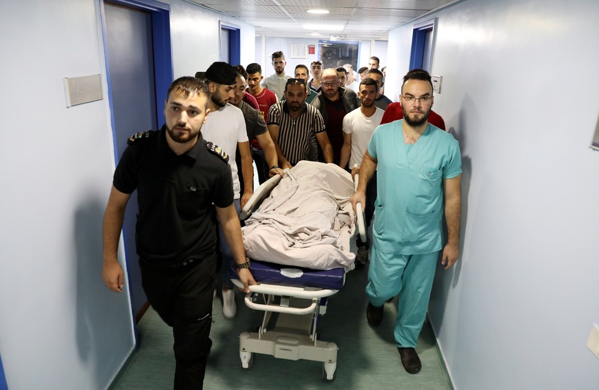 epa09374892 Palestinians carry the body of 12-years old Moayad Al Alami, during his funeral in the West Bank town of Beit Aomr, near Hebron, 28 July 2021. Palestinian media reports that Al -Alami was  ...