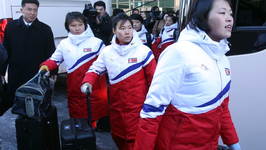 epa06471985 Members of a North Korean Olympic advance team and its women&#039;s ice hockey players cross into South Korea via the customs, immigration and quarantine office in Paju, South Korea, 25 Ja ...