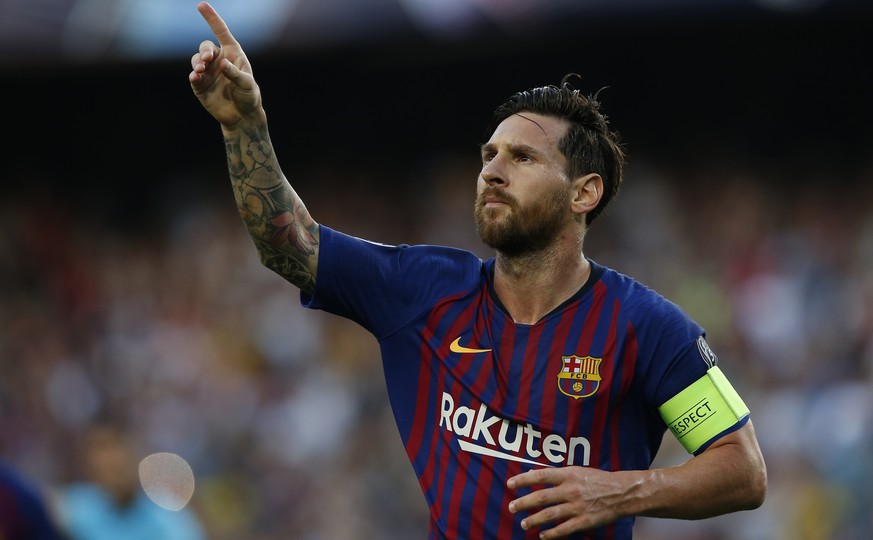 Barcelona forward Lionel Messi celebrates after scoring the opening goal of his team during the group B Champions League soccer match between FC Barcelona and PSV Eindhoven at the Camp Nou stadium in  ...