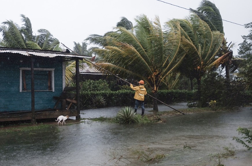 A man fixes the roof of a home surrounded by floodwaters brought on by Hurricane Eta in Wawa, Nicaragua, Tuesday, Nov. 3, 2020. Eta slammed into Nicaragua&#039;s Caribbean coast with potentially devas ...