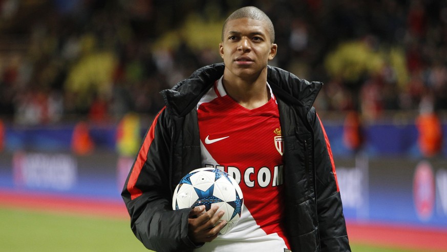 FILE - In this file photo dated Wednesday April 19, 2017, Monaco&#039;s Kylian Mbappe hold a soccer ball after the Champions League quarterfinal second leg soccer match between Monaco and Dortmund at  ...