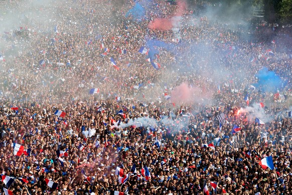 epa06891385 French soccer fans cheer their team after the first goal for France during the FIFA World Cup 2018 final soccer match between Croatia and France, at the fan zone in Paris, France, 15 July  ...