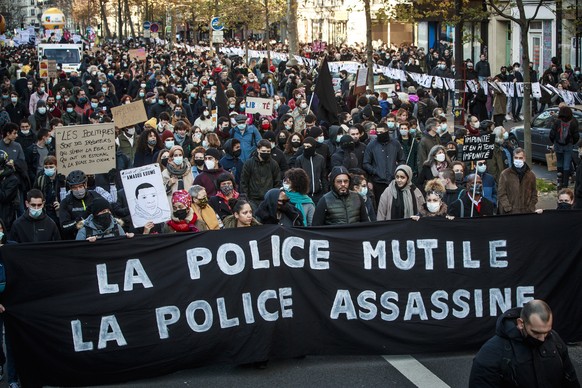epa08849540 Protesters holds a banner reading &#039;Police Mutilates, Police Kills&#039; during a demonstration against the newly passed controversial global security law, in Paris, France, 28 Novembe ...
