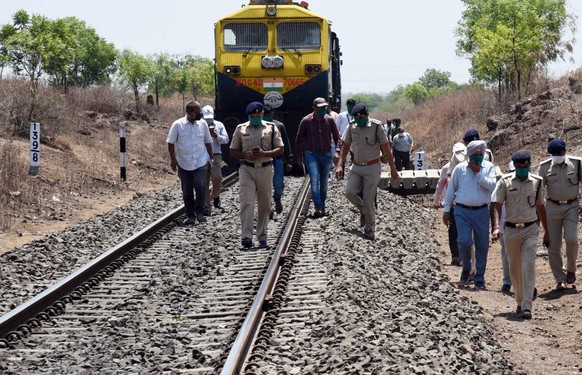 epa08409344 Officials and police inspect at the site of train mishap in which 15 migrant workers were killed near Aurangabad, India, 08 May 2020. According to news reports, atleast 15 migrant workers  ...