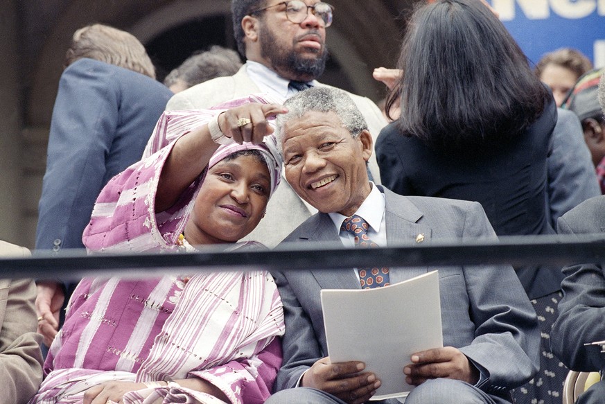 FILE - This June 20, 1990 file photo shows Winnie Mandela pointing out something in the crowd to her husband Nelson Mandela, during a welcoming ceremony at New York&#039;s City Hall as they kicked of  ...