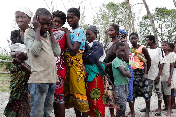 epa07458899 People on a line wait for donation in the province of Sofala, central Mozambique, 23 March 2019. The National Disasters Management Institute of Mozambique said 417 people lost their lives  ...