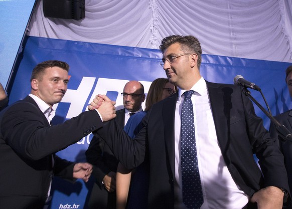 epa05535682 Leader of the Croatian Democratic Union (HDZ) Andrej Plenkovic (R) celebrates the victory of his party in the parliamentary elections in downtown Zagreb, Croatia, 11 September 2016. Accord ...