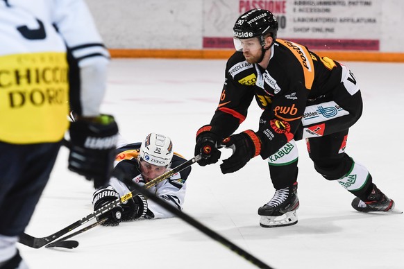 Ambri&#039;s player Diego Kostner, left, fight for the puck with Bern&#039;s player Ted Brithen, right, during the friendly match of National League A (NLA) Swiss Championship 2020/21 between HC Ambri ...