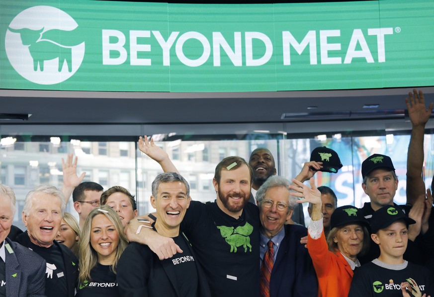 FILE - In this May 2, 2019, file photo Ethan Brown, center, CEO of Beyond Meat, attends the Opening Bell ceremony with guests to celebrate the company&#039;s IPO at Nasdaq in New York. Plant-based mea ...