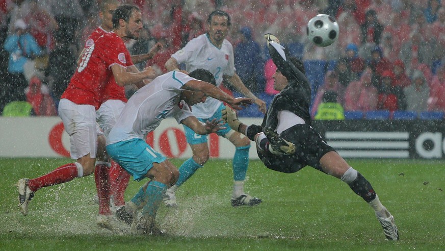 epa01377572 Swiss keeper Diego Benaglio (R) saves a shot by Turkish Arda Turan (2nd L) while Swiss Patrick Mueller (L) and Turkish Servet Cetin (back) look on during the EURO 2008 preliminary round gr ...